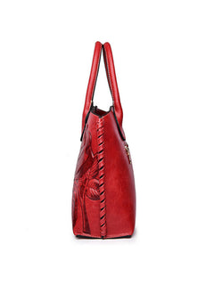 Side view of red embossed rose vegan leather tote bag