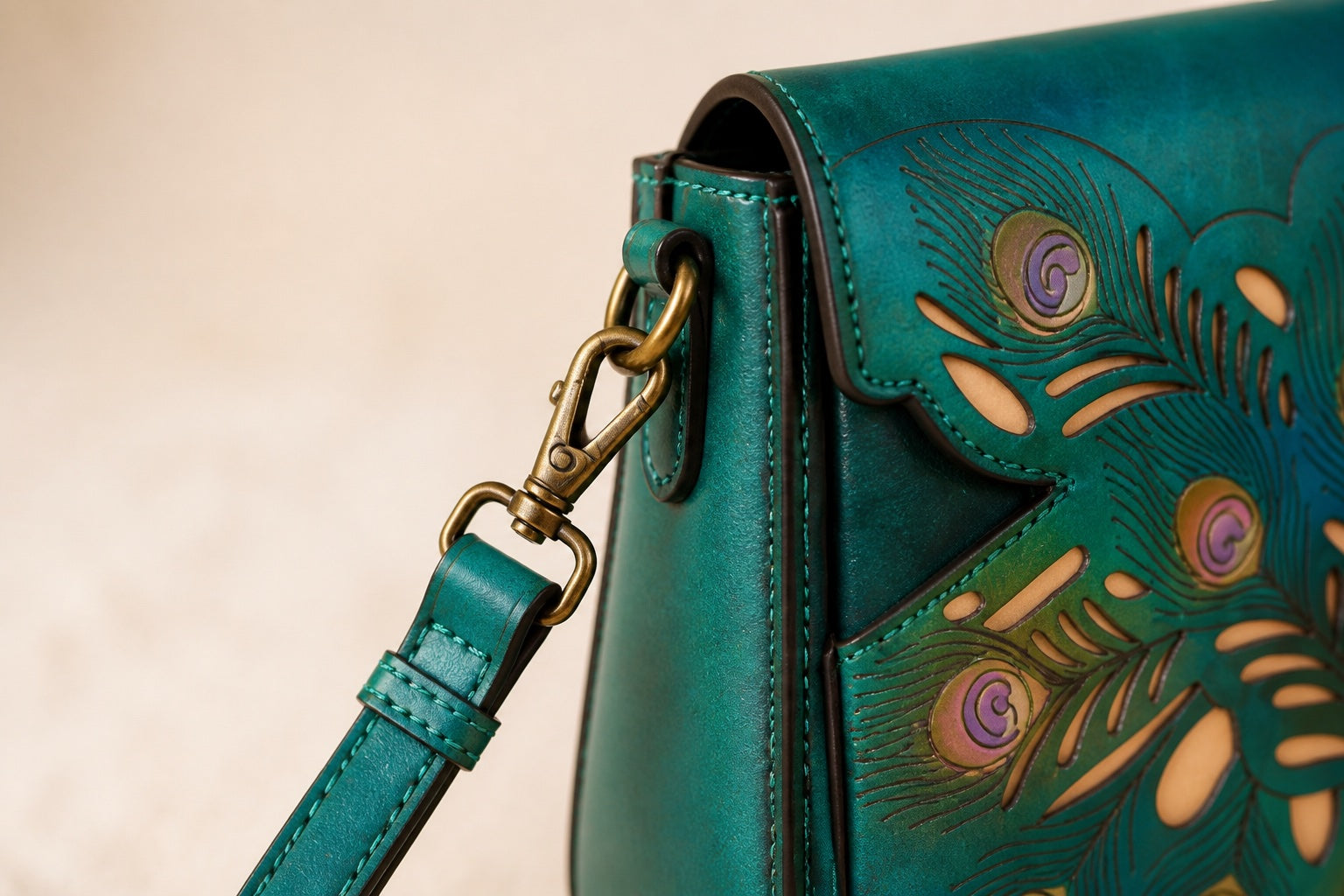 Editorial close-up of antique-toned hardware on the teal Peacock Bag